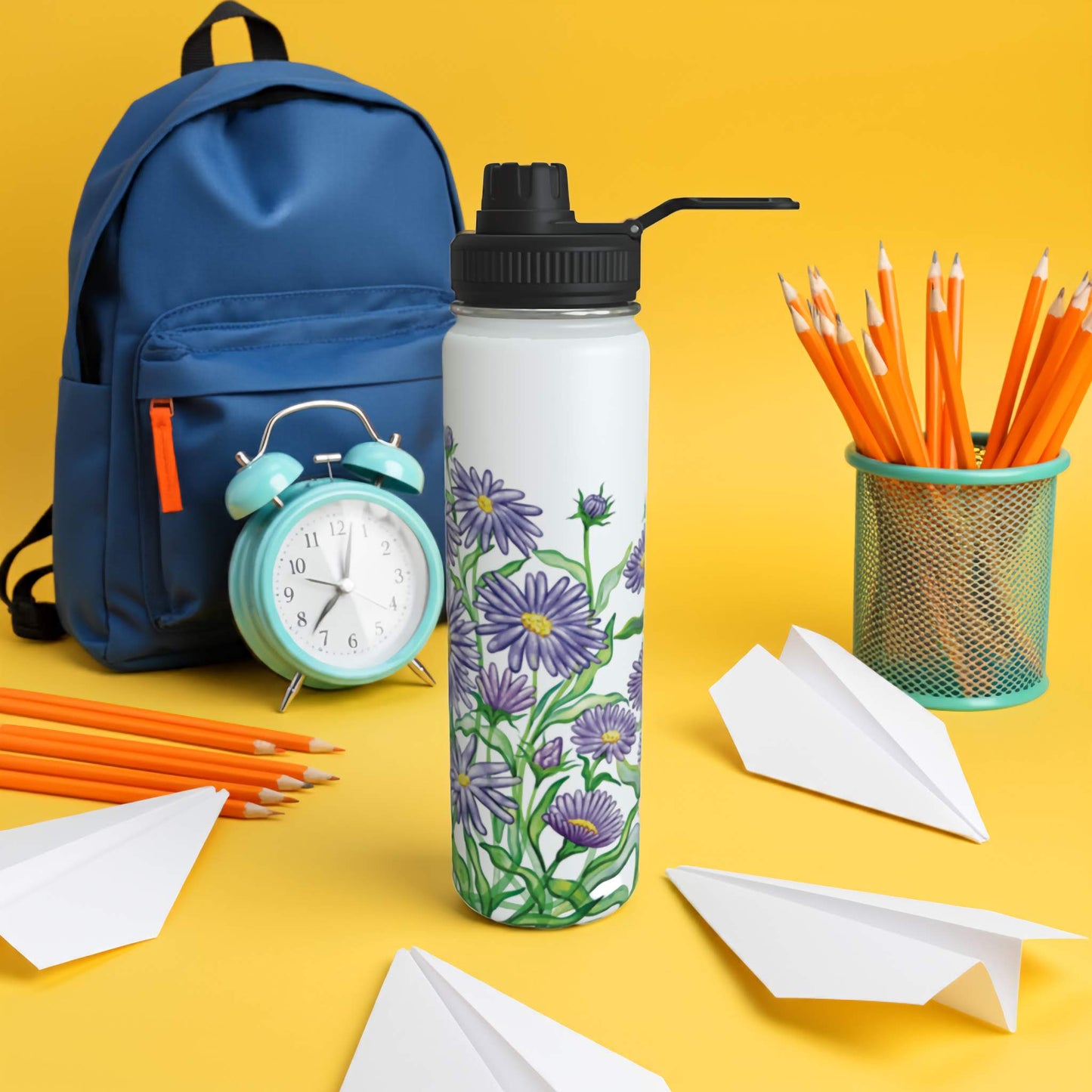 Floral-patterned water bottle with backpack, pencils, and paper airplanes on a bright yellow background