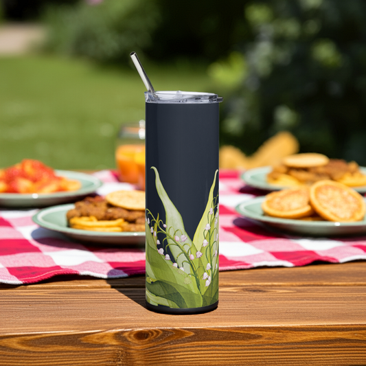 A Lily of the Valley tumbler on a picnic table with food

